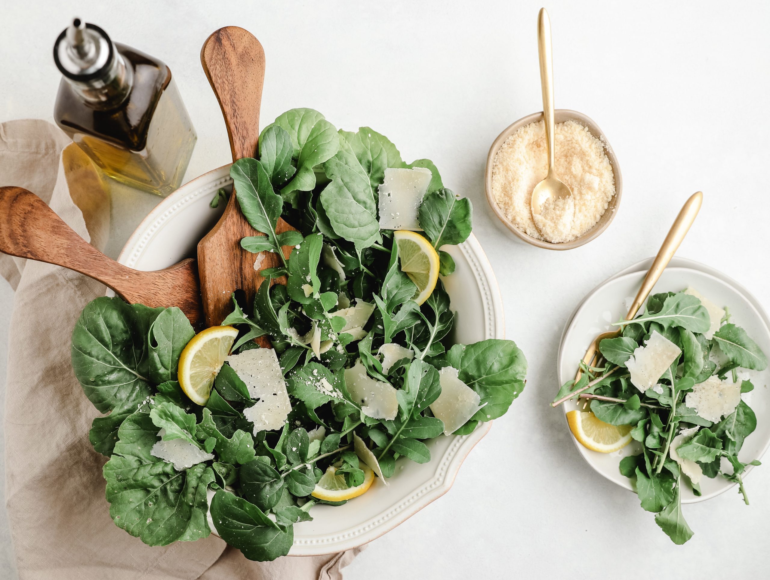 Spinach salad with lemon and cheese garnishes.