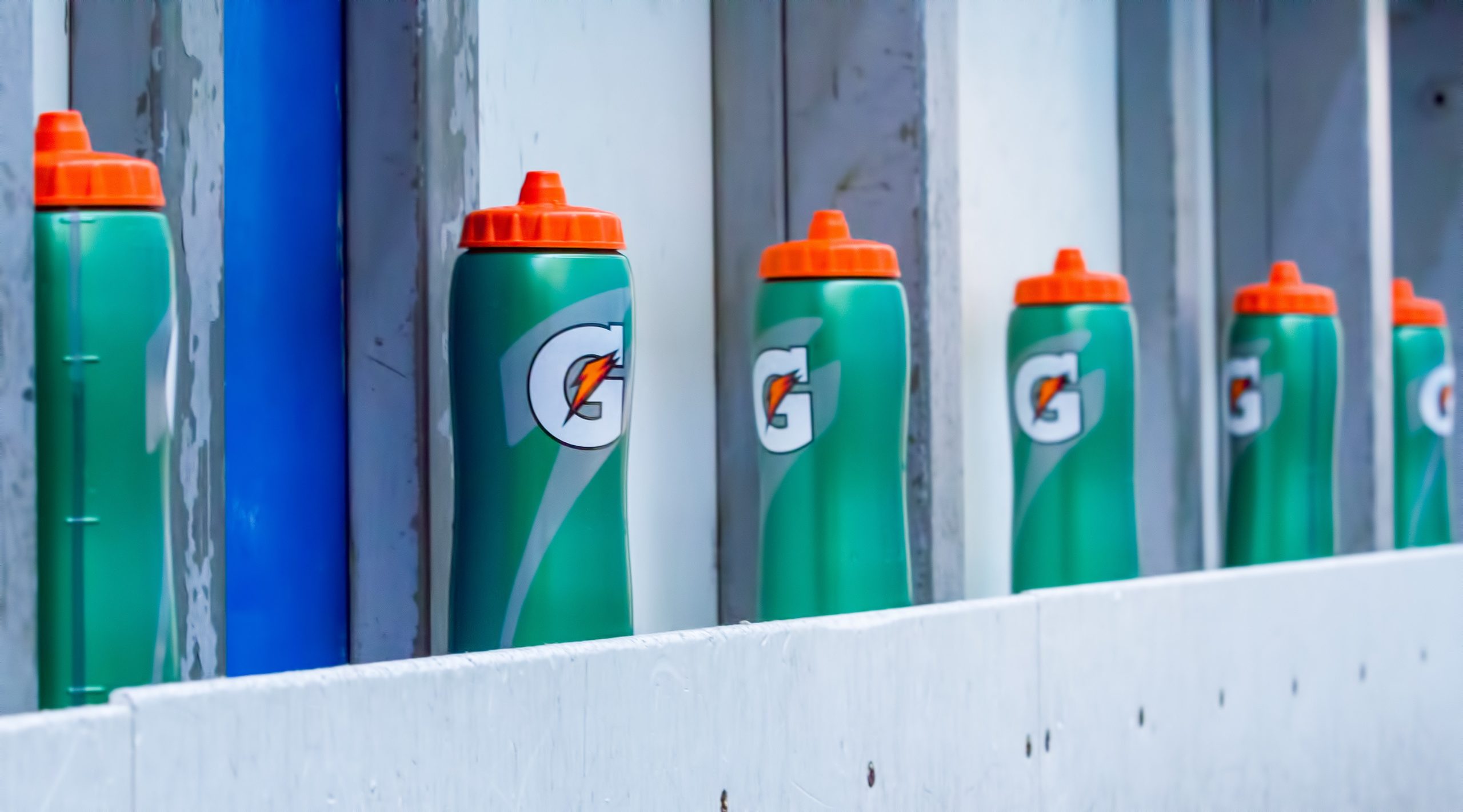 Collection of Gatorade bottles on a wall. Sports drinks contain large amounts of caffeine.