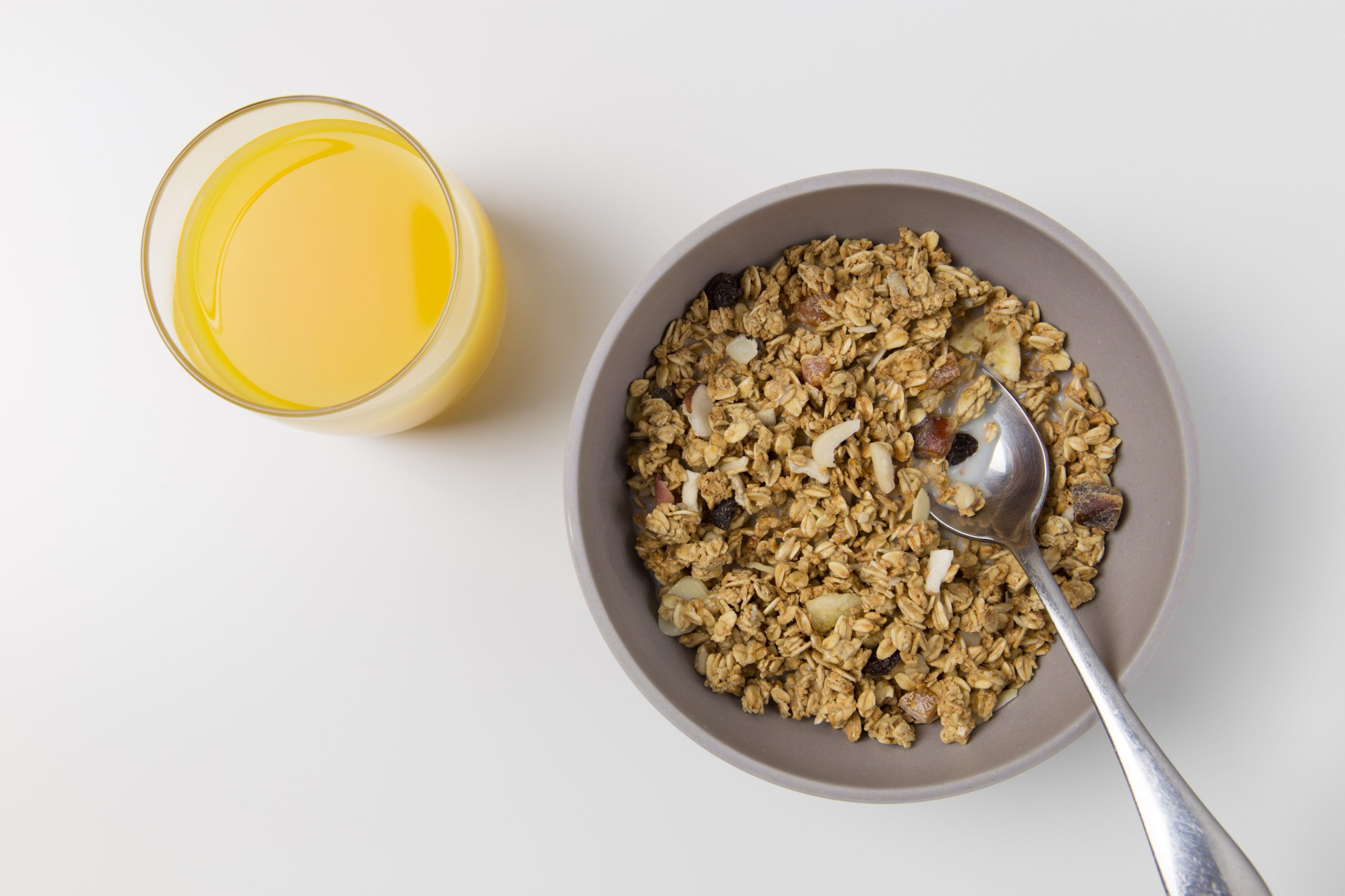 Bowl of cereal with orange juice. Fortified cereal is a great source of ion and can help reduce our risk of developing anemia.