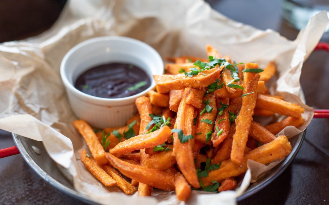 Bowl of sweet potato fries with a dip. Carbohydrates are an important source of energy for the body.