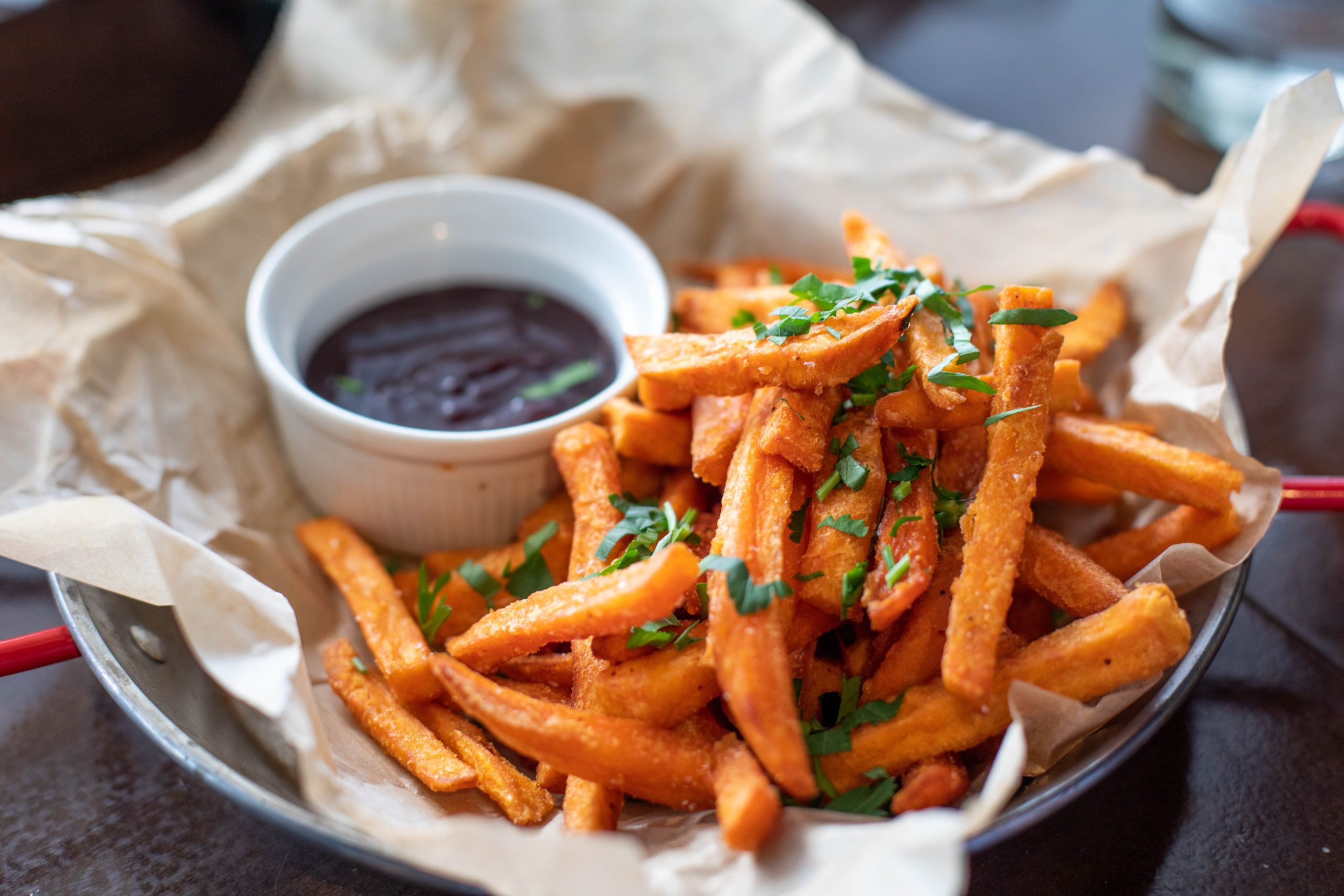 Bowl of sweet potato fries with a dip. Carbohydrates are an important source of energy for the body.