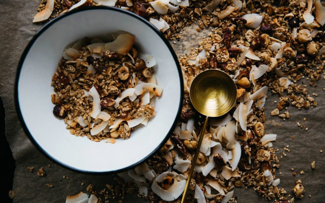 Bowl of grains, nuts and coconut shavings. This is meal is packed with fibre. There are many health benefits of fibre.